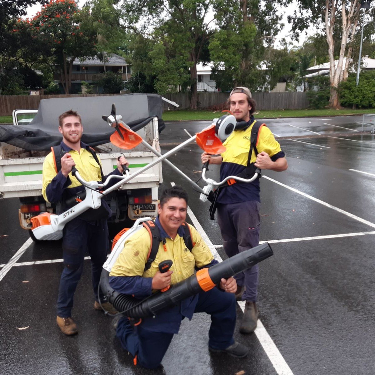 Three crew posing with their gear after a job