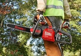 Kress battery-electric chainsaw in use by a Grolife crew member